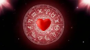 Cuore rosso al centro di un cerchio zodiacale su sfondo stellato