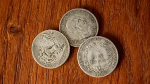 Tre monete rare italiane in argento su sfondo di legno
