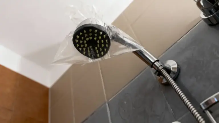 Soffione della doccia con sacchetto di plastica trasparente avvolto attorno alla testa